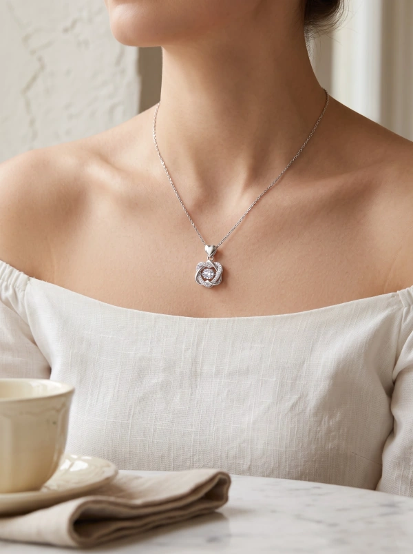 Silver-tone interwoven heart pendant necklace with a round clear center, shared appearance image 2